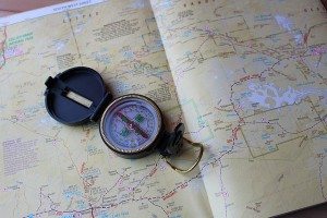 Photo of a compass and map