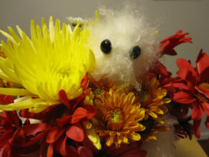 close-up of the Hug Monster in a bouquet of flowers